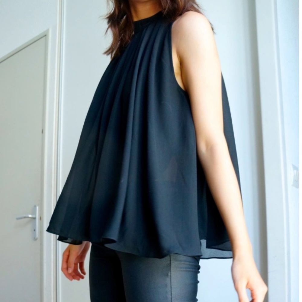 Flowy sheer mock neck sleeveless blouse